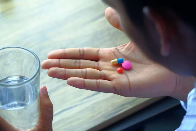 person taking supplements